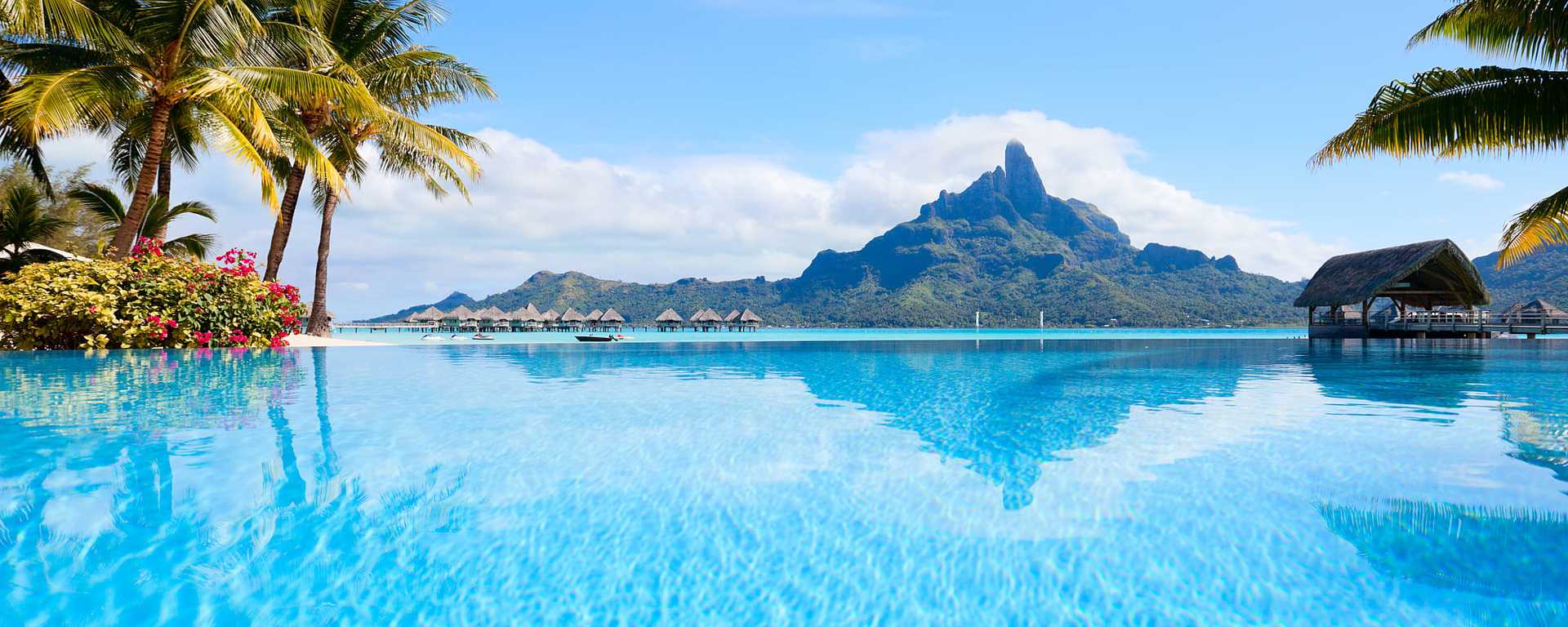 Resort pool with bungalows and Mount Otemanu in Bora Bora, French Polynesia