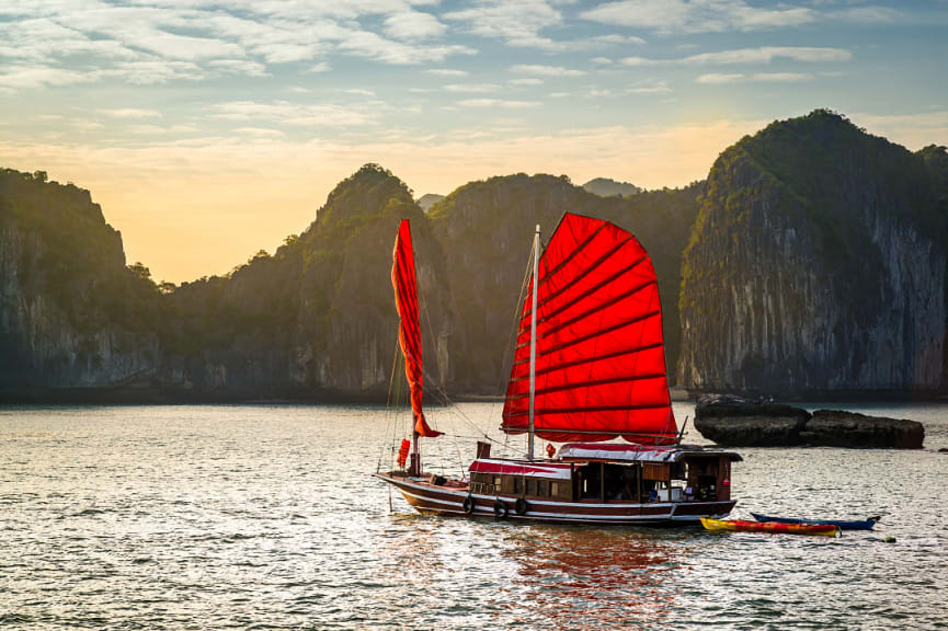 A red junk boat sailing in Ha Long Bay in Vietnam.