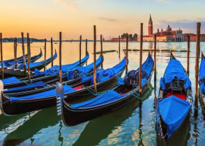 Row of traditional blue-colored gondolas parked on the Grand Canal, Venice, Italy