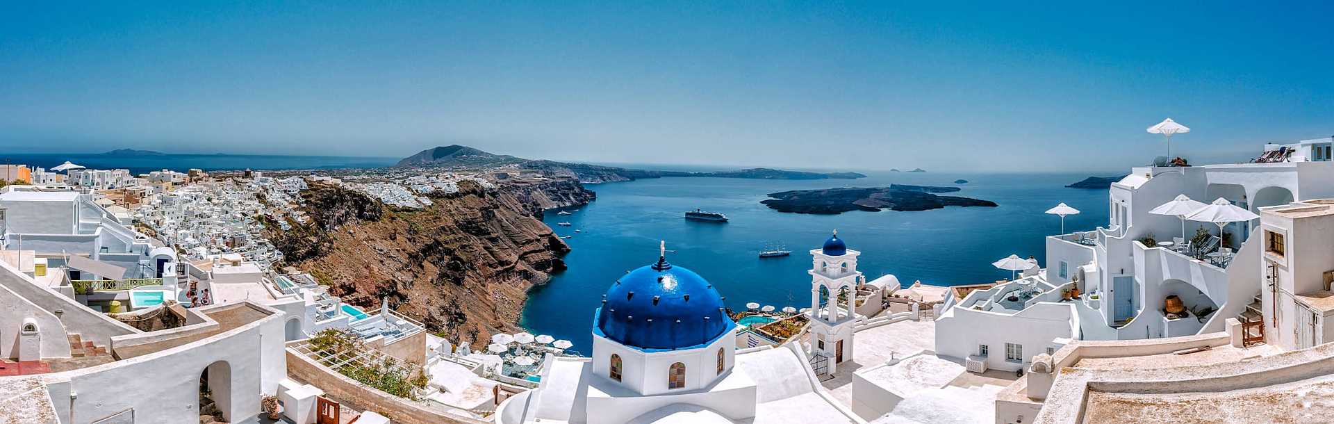 View of caldera from Santorini blue domed buildings.