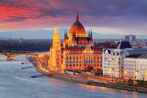 Hungarian Parliament on the banks of the Danube River in Budapest at sunset