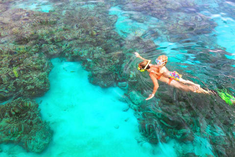 Mother and son snorkeling while on vacation