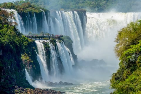 Travelers viewing The Devil's Throat from a platform on the Argentinian side of Iguazu Falls 